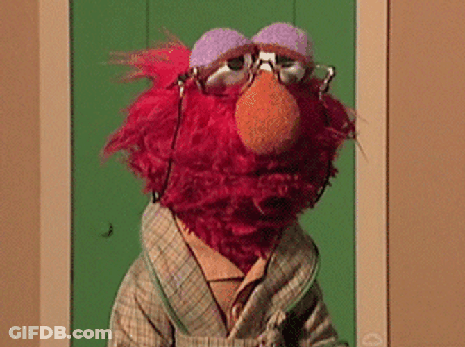 Old Elmo Hit By Rolled Paper GIF