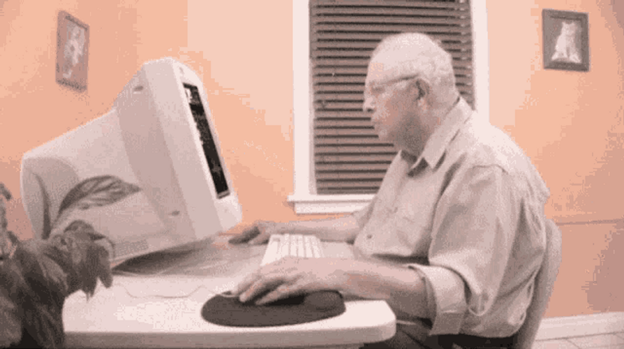 Old Man Using Vintage Computer GIF