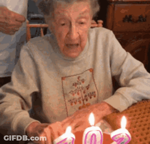 Old Woman Blowing Birthday Candles With Falling Dentures GIF
