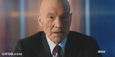 Older Bald Man In Suit And Tie Looking At Camera GIF