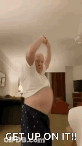 Older Man Dancing In Living Room Holding Arms Up GIF