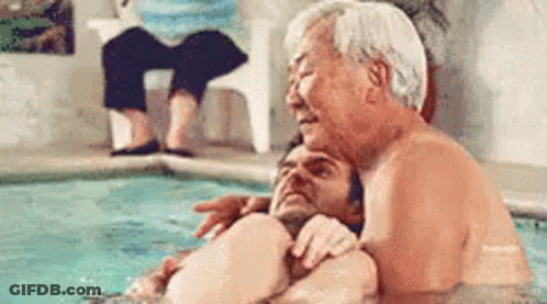 Older Man Hugging Younger Man In Pool GIF