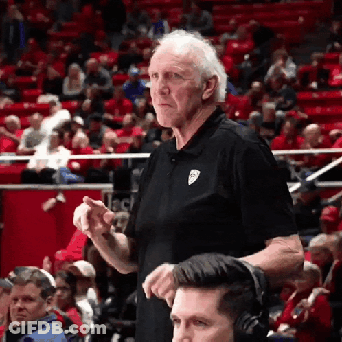 Older Man In Black Shirt With Jeep Logo In Front Of Crowd GIF