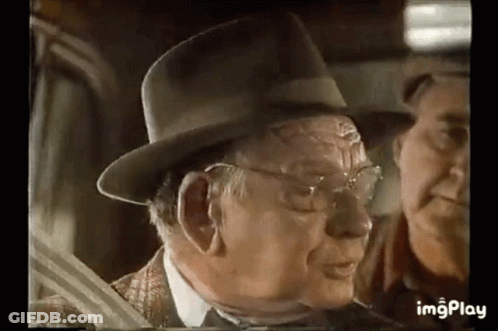 Older Man In Hat Talking To Man In Car GIF