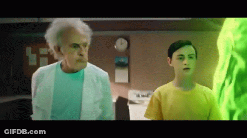 Older Man In Lab Coat Next To Boy In Yellow GIF