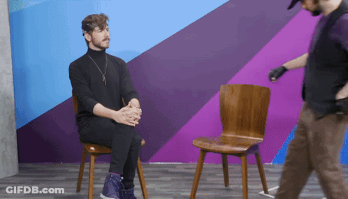 Older Man In Plaid Shirt Sitting In Front Of Prime Logo GIF