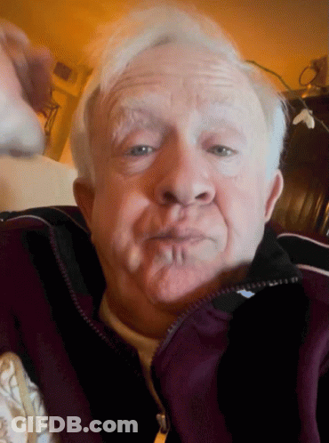 Older Man In Purple Jacket Making Silly Face GIF