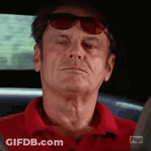 Older Man In Red Shirt Sitting In Car GIF