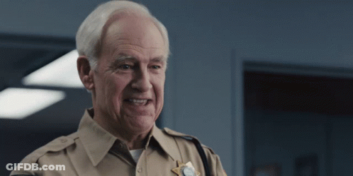 Older Man In Sheriff Uniform Smiling GIF