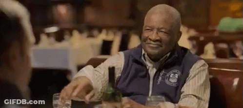 Older Man Sitting At Table With Wine And Water GIF