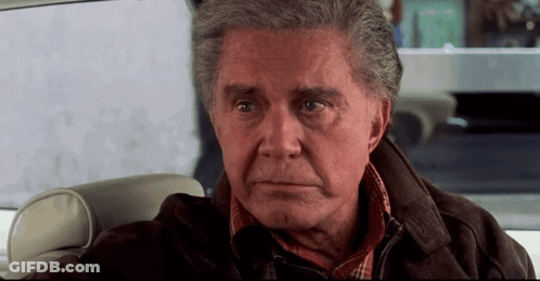 Older Man Sitting In Back Seat Looking At Camera GIF