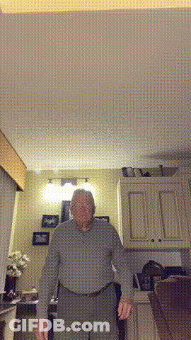 Older Man Standing In Living Room GIF