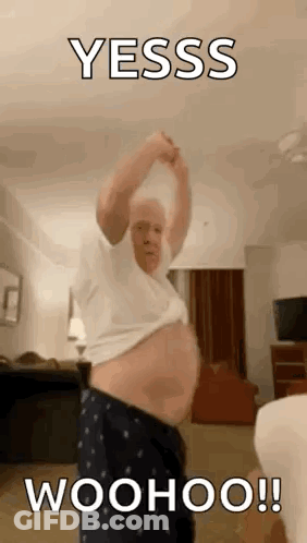 Older Man Standing Shirtless In Living Room GIF