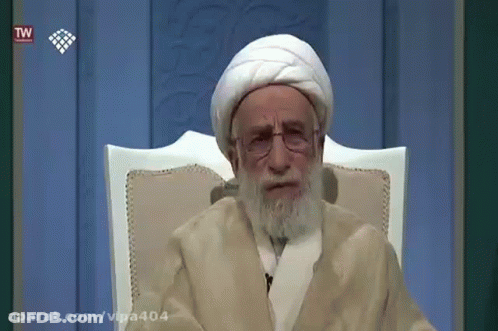 Older Man With Beard And Glasses Sitting GIF
