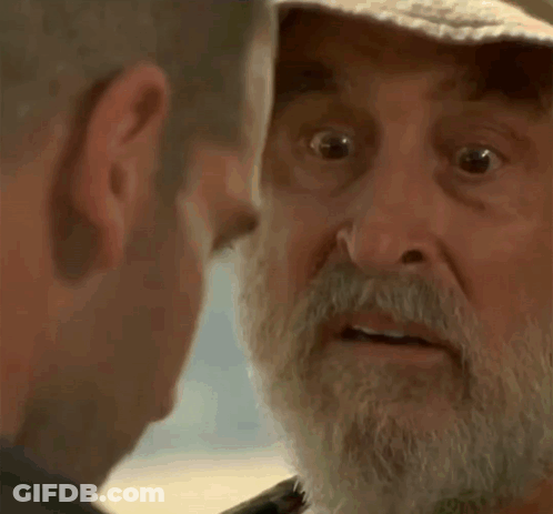 Older Man With Beard And Hat Looking At Another Man GIF