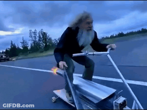 Older Man With Beard Riding Skateboard GIF