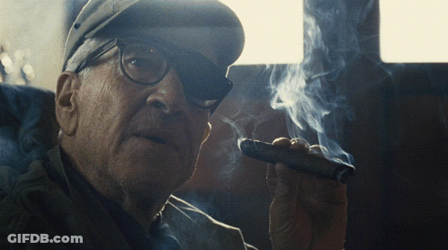 Older Man With Glasses And Hat Smoking Cigar GIF