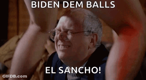 Older Man With Glasses Sitting In Front Of Naked Man's Legs GIF