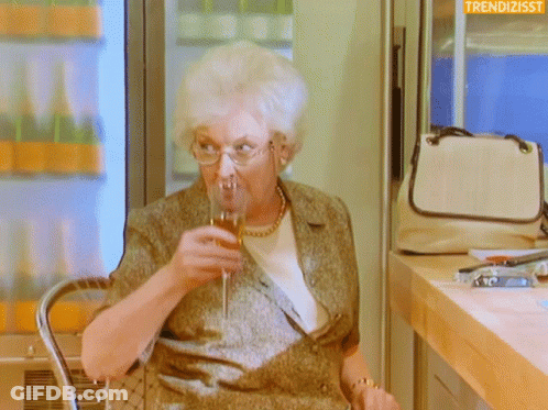 Older Woman Drinking Wine With Trendizsst Logo GIF