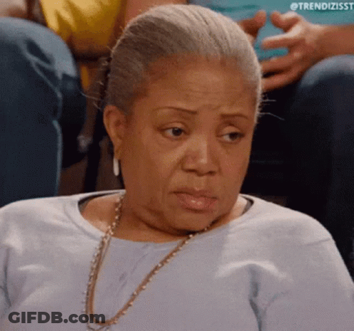 Older Woman In Blue Shirt And Gold Necklace GIF