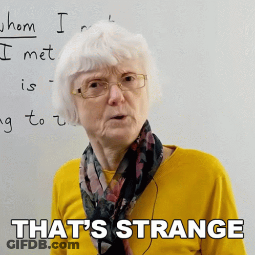 Older Woman In Glasses And Yellow Sweater Says That's Strange GIF