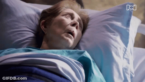 Older Woman Laying In Hospital Bed With RC Letters GIF