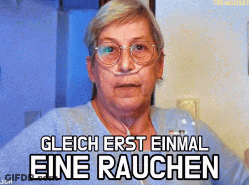 Older Woman With Glasses And Nasal Cannula Saying Glich Erst Einmal Eine Rauchen GIF