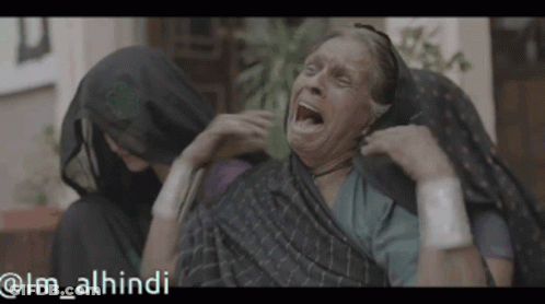 Older Woman With Mouth Open Comforted By Woman In Hijab GIF