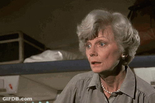 Older Woman With Pearl Necklace And Earrings Surprised GIF