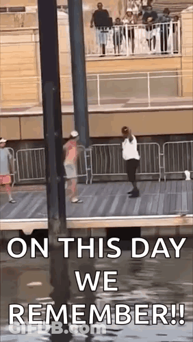 On This Day We Remember ! A Man And A Woman Are Standing On A Pier . GIF