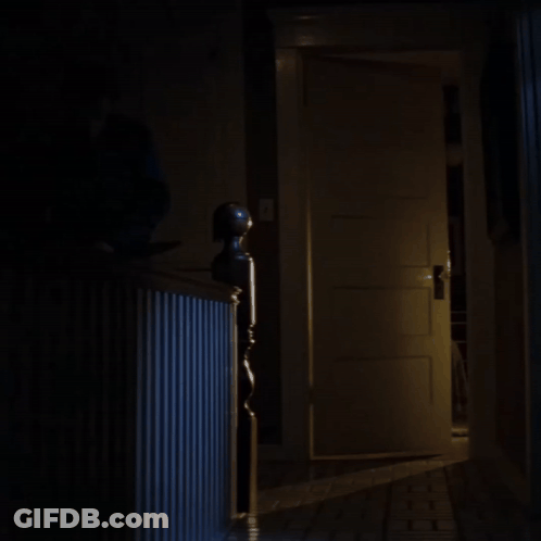 Open Door In Dark Hallway With Staircase GIF