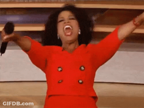 Oprah Winfrey Is Singing Into A Microphone With Her Arms Outstretched . GIF