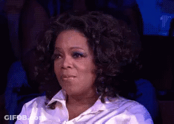 Oprah Winfrey Is Sitting In A Chair With Her Eyes Closed And Making A Funny Face . GIF