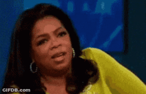 Oprah Winfrey Is Wearing A Yellow Shirt And Earrings GIF