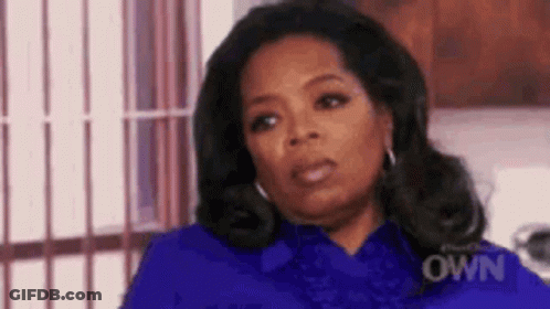 Oprah Winfrey Wearing Blue Shirt And Earrings GIF