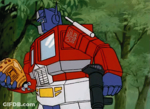 Optimus Prime From The Transformers Holding A Gun GIF
