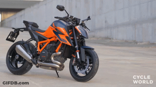 Orange And Black Motorcycle Parked Saying Cycle World GIF