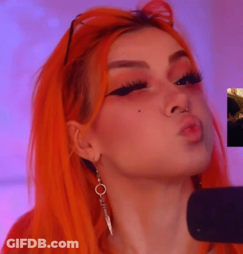 Orange-Haired Woman Blowing Kiss Earrings Nose Ring GIF