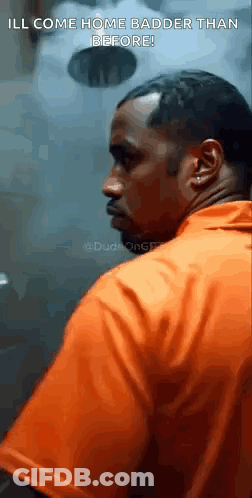 Orange Shirt Man In Prison Cell Looking At Camera GIF