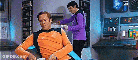 Orange Shirt Man Sits, Purple Shirt Man Works GIF