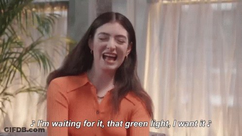 Orange Shirt Woman Laughing Waiting For Green Light GIF