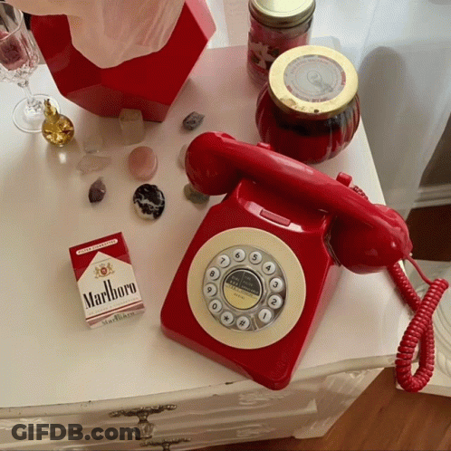Pack Of Marlboro Cigarettes Next To Red Telephone GIF