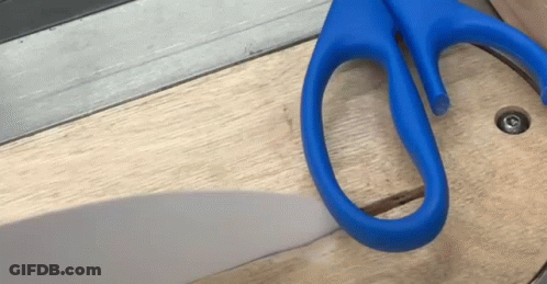 Pair Of Blue Scissors On Wood GIF