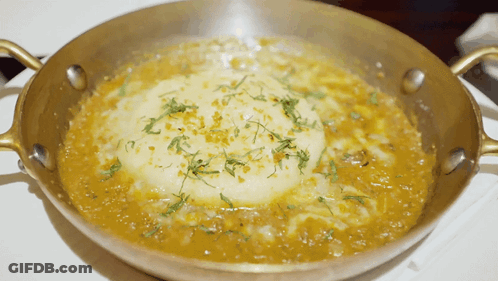 Pan Of Food With Thick Sauce And Crust GIF