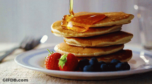 Pancakes Stacked On Top Of Each Other With Syrup Being Poured On Top GIF