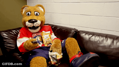 Panther Mascot Sitting On Couch With Chips GIF
