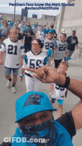 Panthers Fans Walking Down Sidewalk GIF