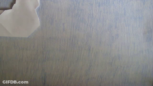 Paper Airplane Folded In Half On Blue Surface GIF
