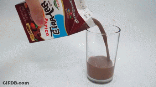 Papico Chocolate Packet Poured Into Glass GIF