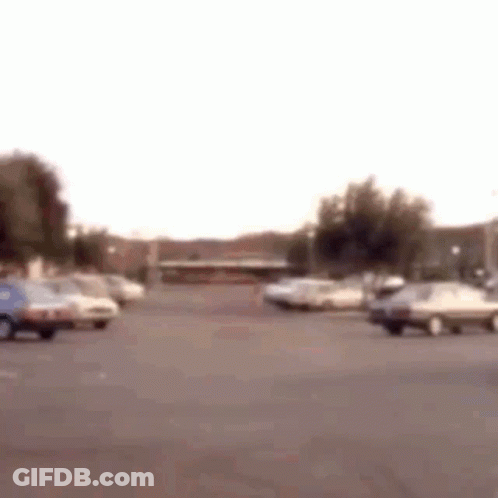 Parking Lot With Cars And Building GIF